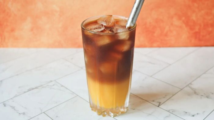 A refreshing glass of orange juice iced coffee, ready to be savored.