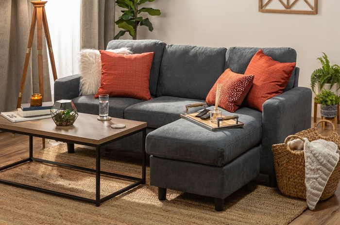 The dark bluish-gray sectional sofa elegantly arranged in a living room.