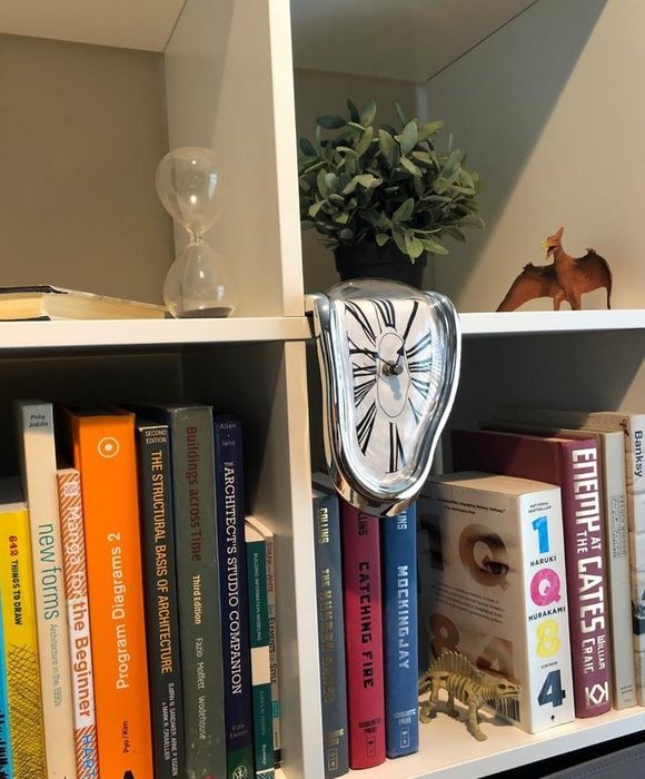 A reviewer's Dali clock on display atop a bookcase.