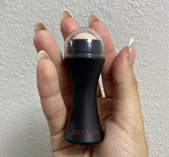 A customer review photo showing them holding the face roller.