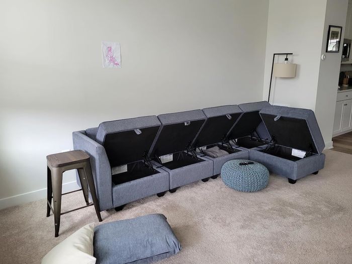 The L-shaped sectional with its storage compartments open.