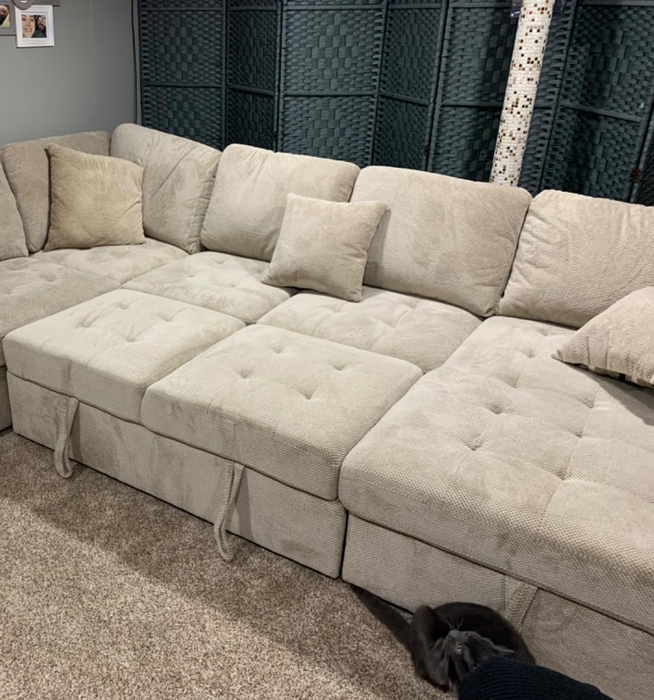 A close-up shot of a beige sleeper sofa, taken by a reviewer.