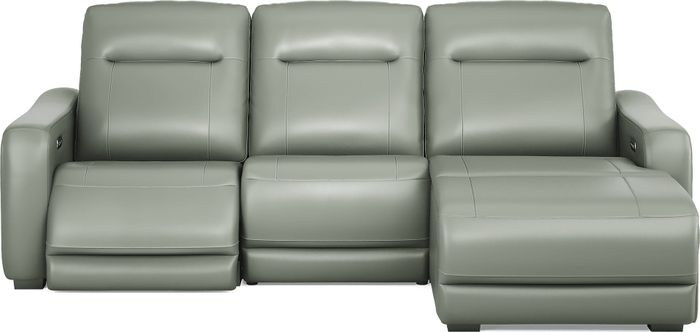 A modern leather sectional sofa featuring reclining seats and a chaise lounge positioned on the right side for maximum comfort.
