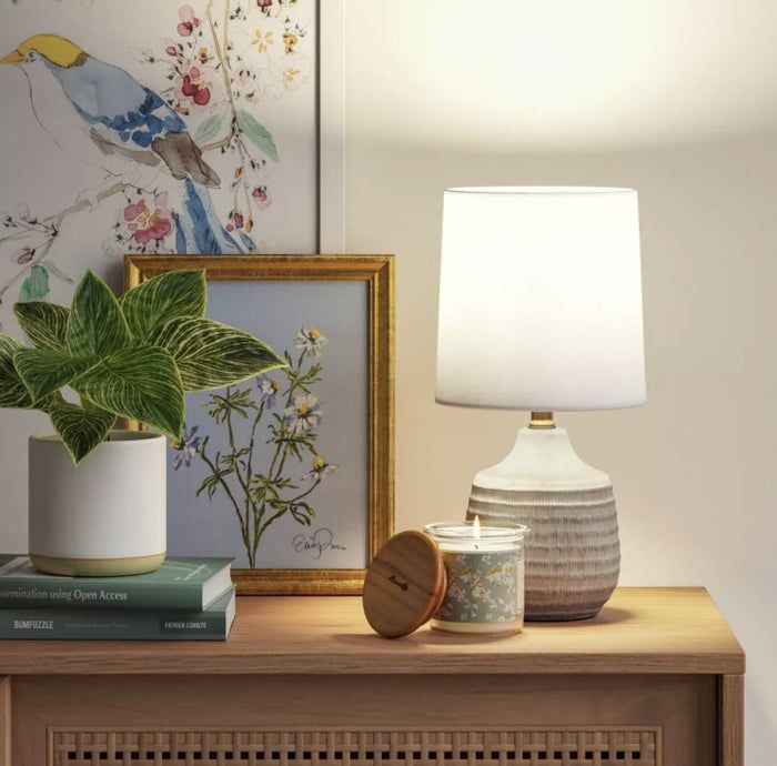 The lamp glowing on a console table