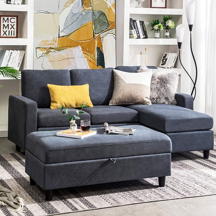 The bluish-gray sectional sofa paired with a matching double ottoman.