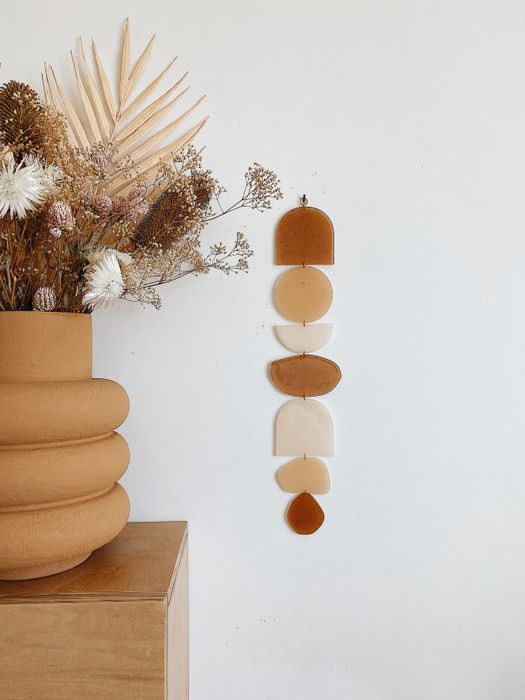 A neutral-colored wall hanging.