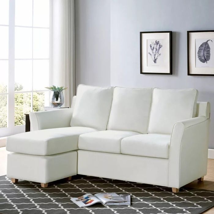 L-shaped sectional sofa featuring a left-facing chaise, showcased in a minimalist living room.