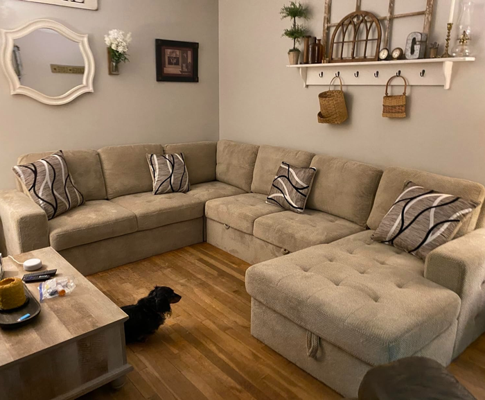 A reviewer’s photo showcasing the tan couch arranged in a different setup.