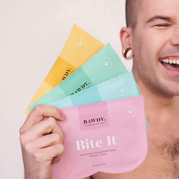 A model holding four packs of butt sheet masks.