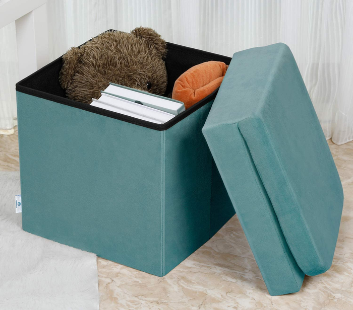 Product in teal with the top removed, revealing books and a teddy bear inside, placed on the floor.