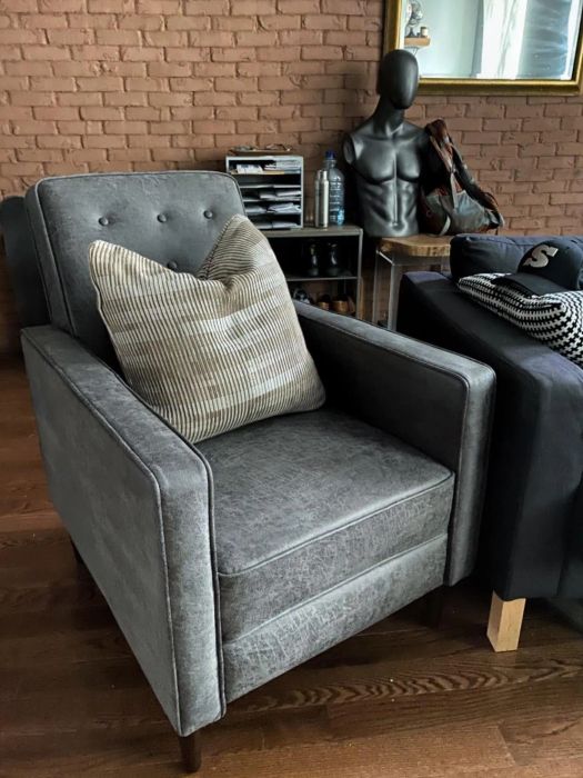 A slate-colored tufted recliner from another reviewer, shown in the upright position
