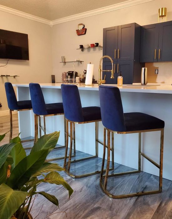 The reviewer's navy blue and gold barstools are pictured in the kitchen.
