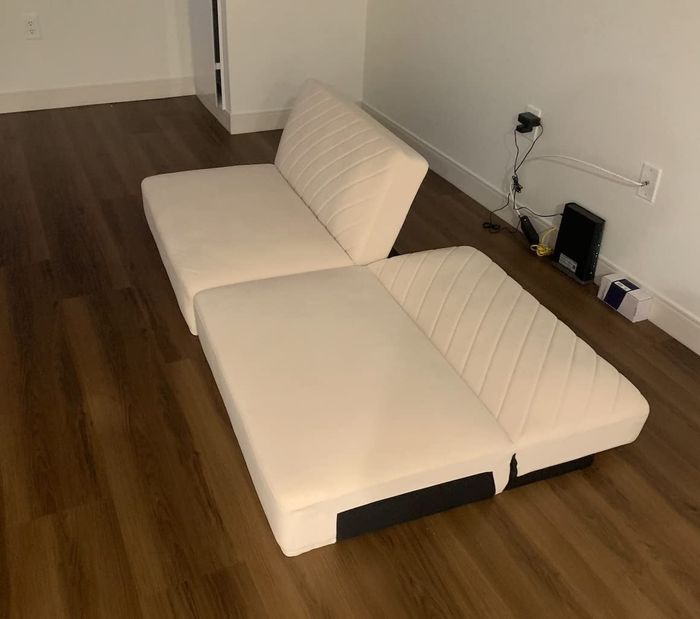 A photo shared by a reviewer showing their white futon without legs, half reclined and the other half upright.