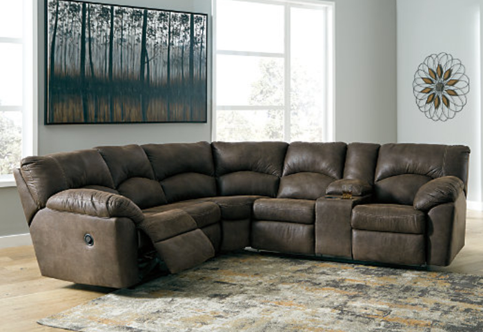 A cozy lifestyle shot of a brown faux leather reclining sectional sofa in a stylish setting.