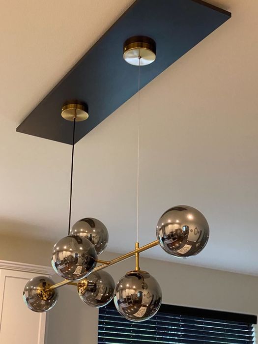 The reviewer’s chandelier is shown in a close-up shot.