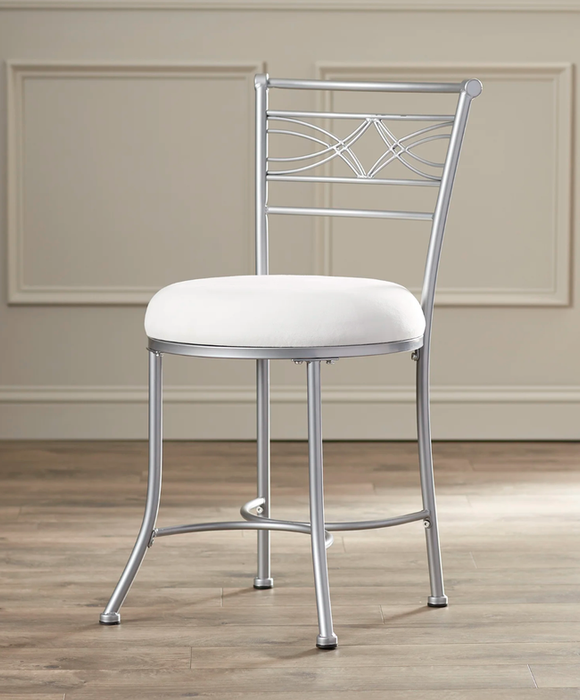 Silver metal chair with a white cushioned seat and metal backrest, placed on a hardwood floor.