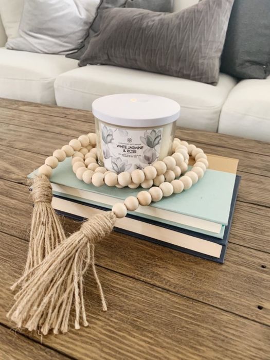 The garland draped around a reviewer's candle, adding a decorative touch to the space.