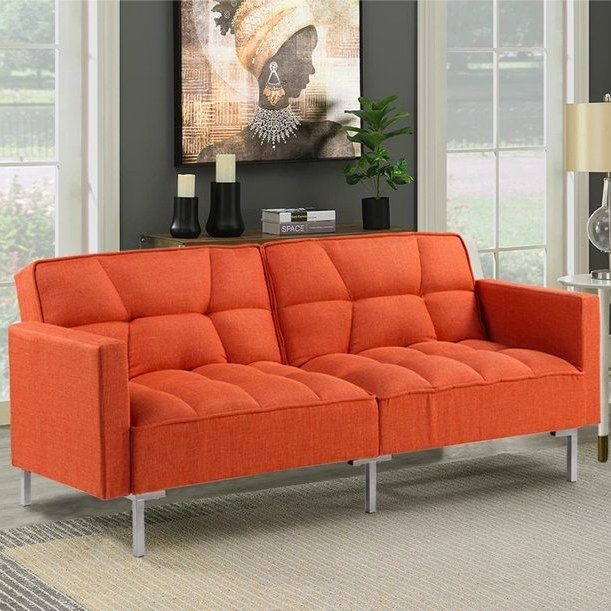 An orange sofa placed in a living room with modern gray walls, offering a striking pop of color.
