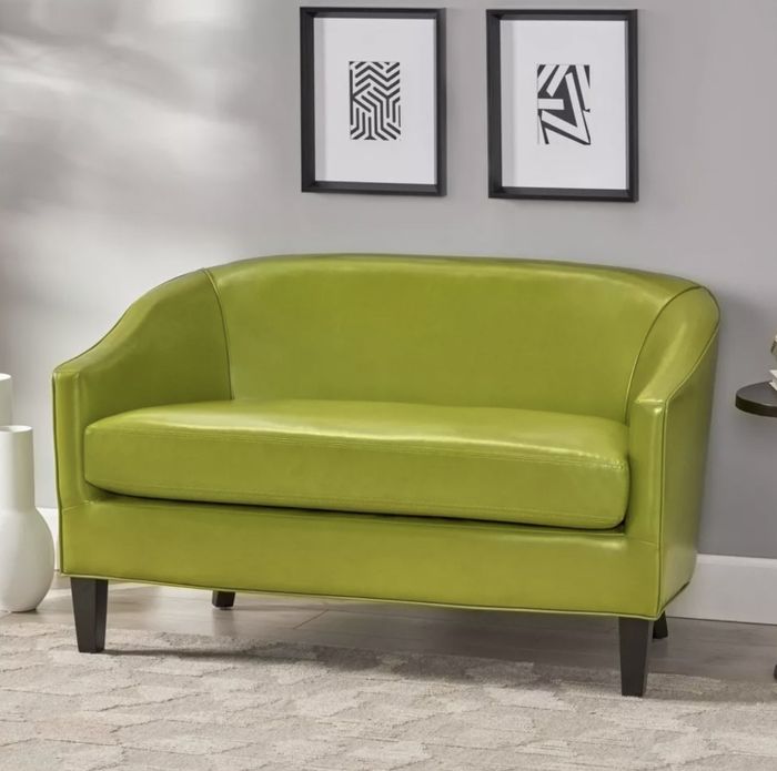 The green faux-leather loveseat