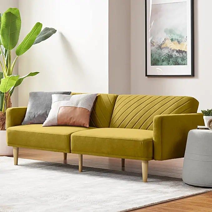 A bright yellow futon adorned with two decorative throw pillows.