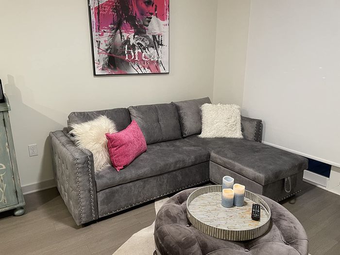 A reviewer’s photo of the gray couch, standing upright.