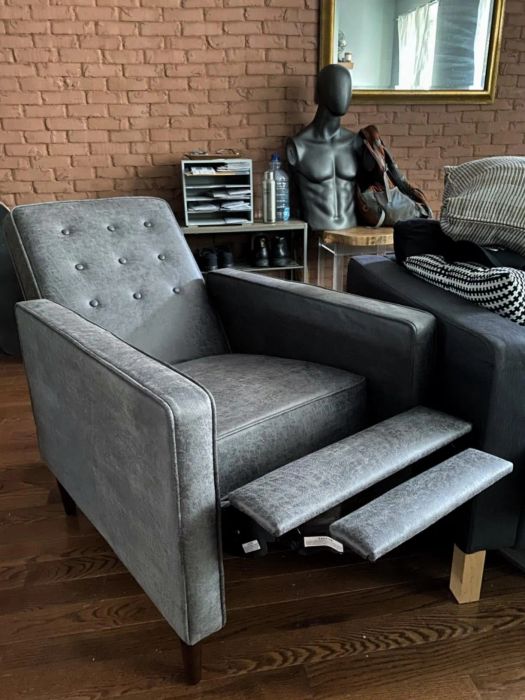 The same reviewer's slate recliner shown in a fully reclined position