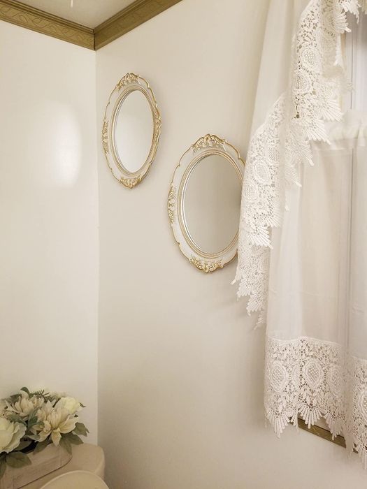 A reviewer's collection of mirrors displayed on a wall, each adding character to the room.