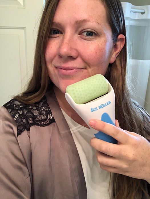 A reviewer using the roller on their face.