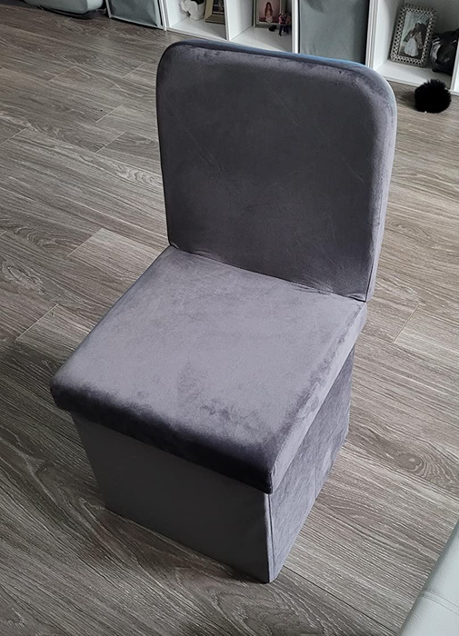 Reviewer image of a gray velvet vanity chair with a high back placed on a hardwood floor.