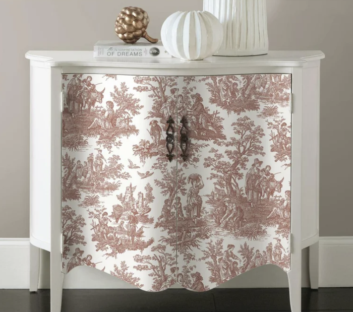 The wallpaper is applied to the front of a nightstand for a fresh, updated look.
