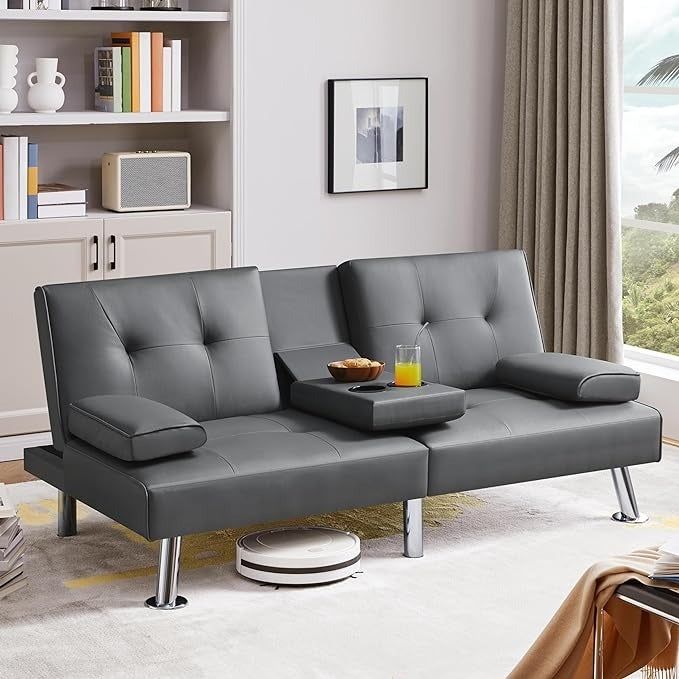 A stylish gray leather futon sofa with adjustable armrests, a center tray for drinks, and a practical design for ultimate relaxation.