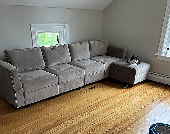 A reviewer’s photo of a stylish gray L-shaped couch.