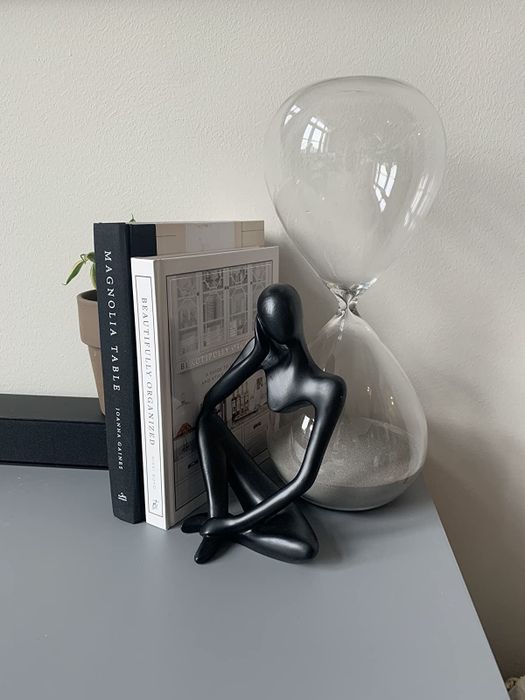A reviewer's black thinker sculpture, a thoughtful addition to the decor.
