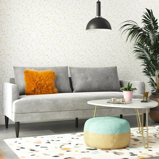 A gray sofa accented with an orange pillow, bringing a stylish touch to any living room.