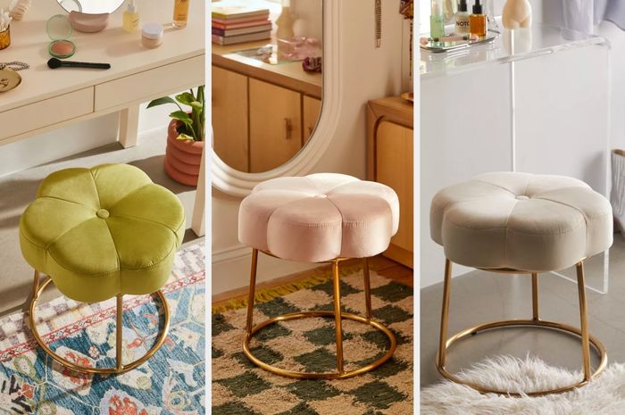 A set of velvet flower-shaped vanity stools in shades of green, purple, and white, each with a metal gold base.