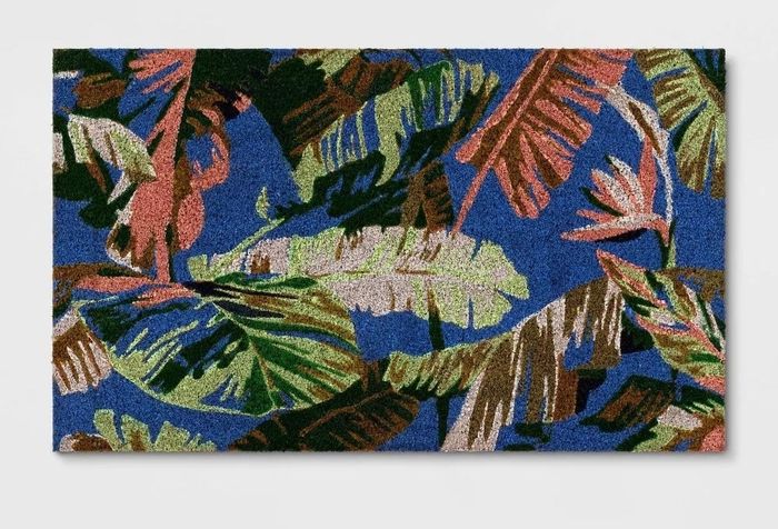 Doormat featuring a tropical leaf pattern