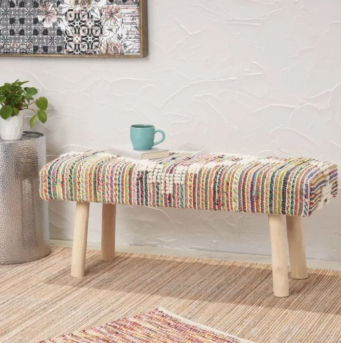 the bench with a book and mug placed on top