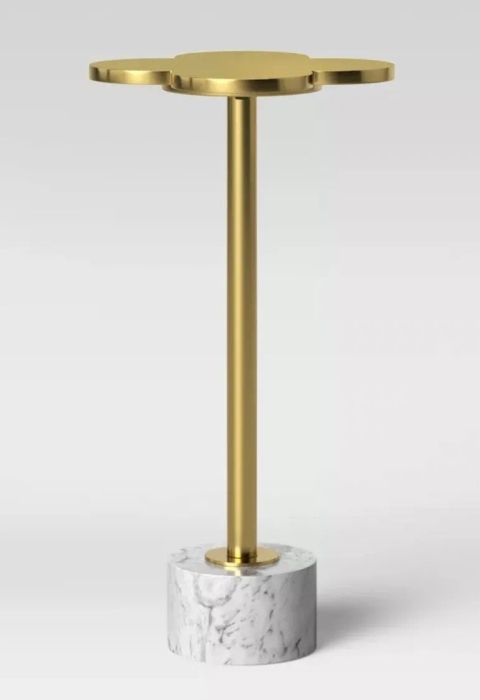 A close-up view of the brass petal-top table