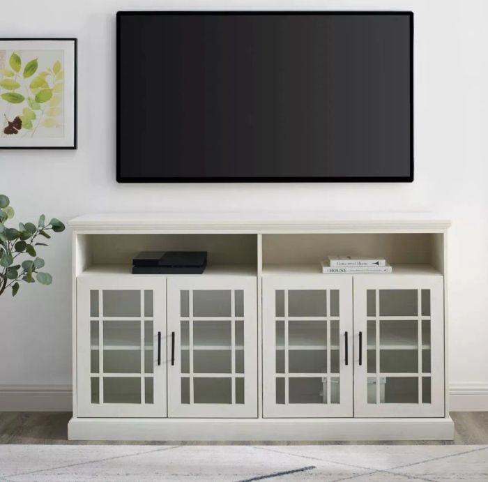 The white stand with a TV mounted on the wall