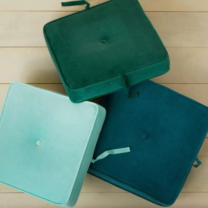 the three green and blue pillows