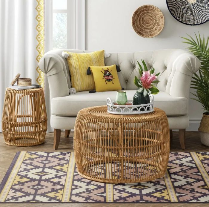 The coffee table with a serving tray on top, placed in front of a sofa alongside a matching accent table