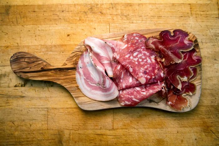 A selection of cured meats arranged on a charcuterie board