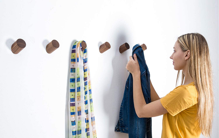 A model hanging a coat on the hook