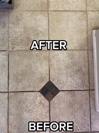 A reviewer's tile floor, with the bottom half covered in dirty brown grout
