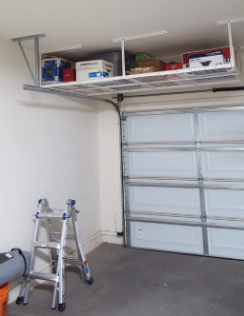 A photo from a reviewer showing the overhead shelving system in place.