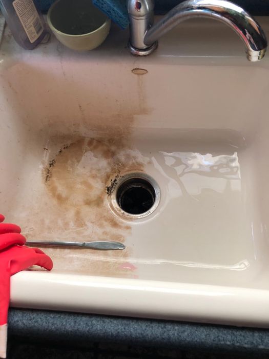 A reviewer's sink, half brown with stains and half clean and white