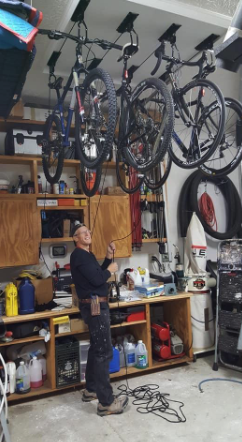 A photo from a reviewer showing their two bikes suspended from the garage ceiling
