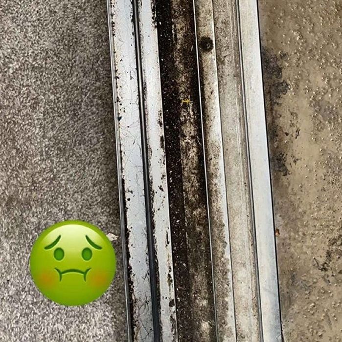 A reviewer's door track covered in dirt and grime.