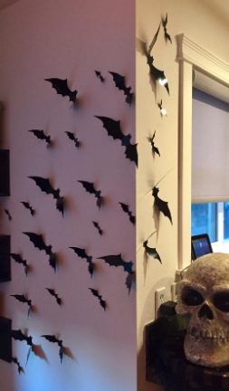 A set of decorative 3D bats displayed on a reviewer's wall
