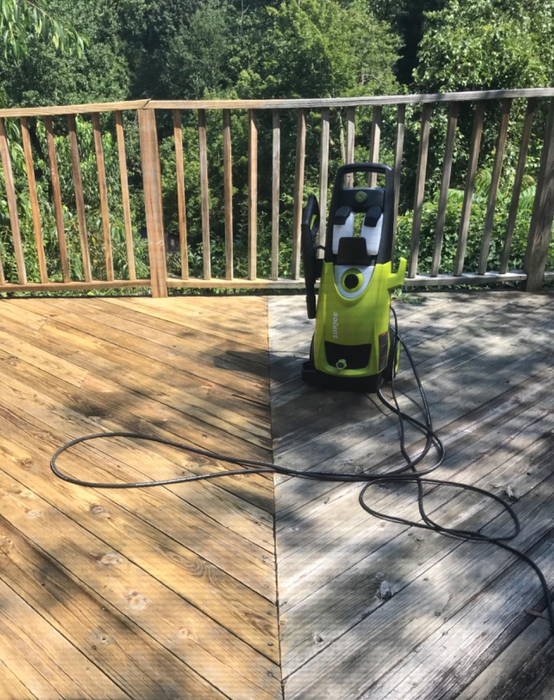 Reviewer photo showing a deck half-cleaned, with one side gray and dull and the other restored to its original look
